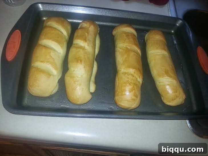 Freshly baked golden brown milk bread loaves straight from the oven.