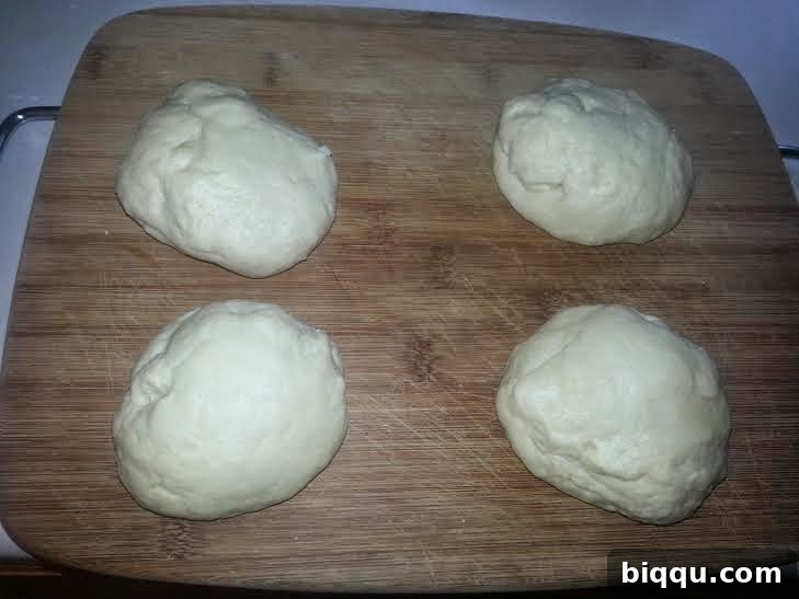Dough divided into four equal pieces.