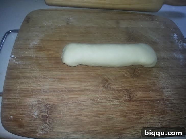 Edges of the rolled dough log folded inwards.