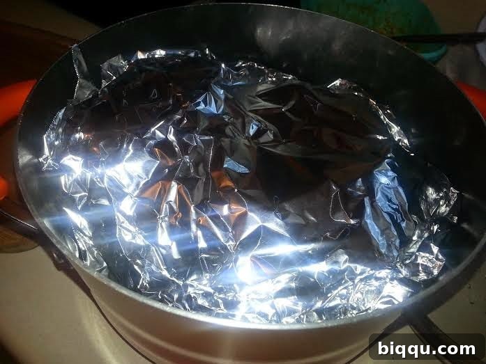 Adding water to the pot for the steaming process.