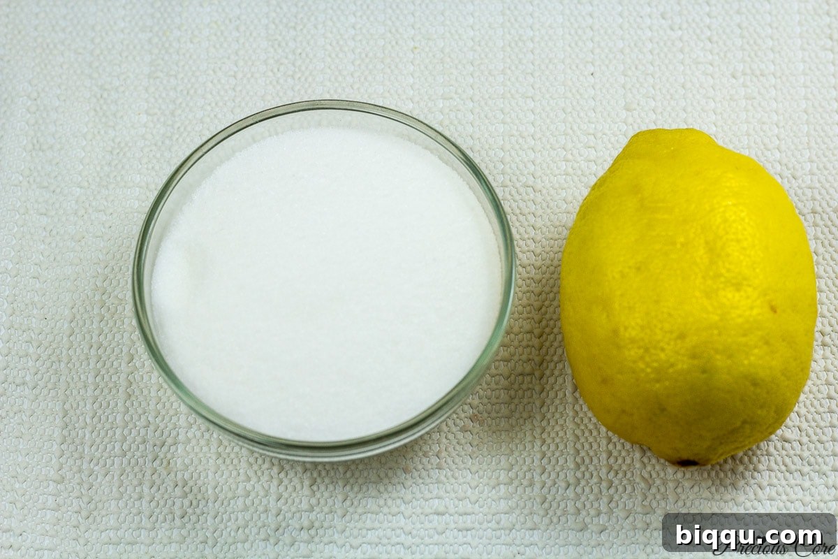 Essential ingredients for mixed berry jam: fresh berries, granulated sugar, and a lemon.