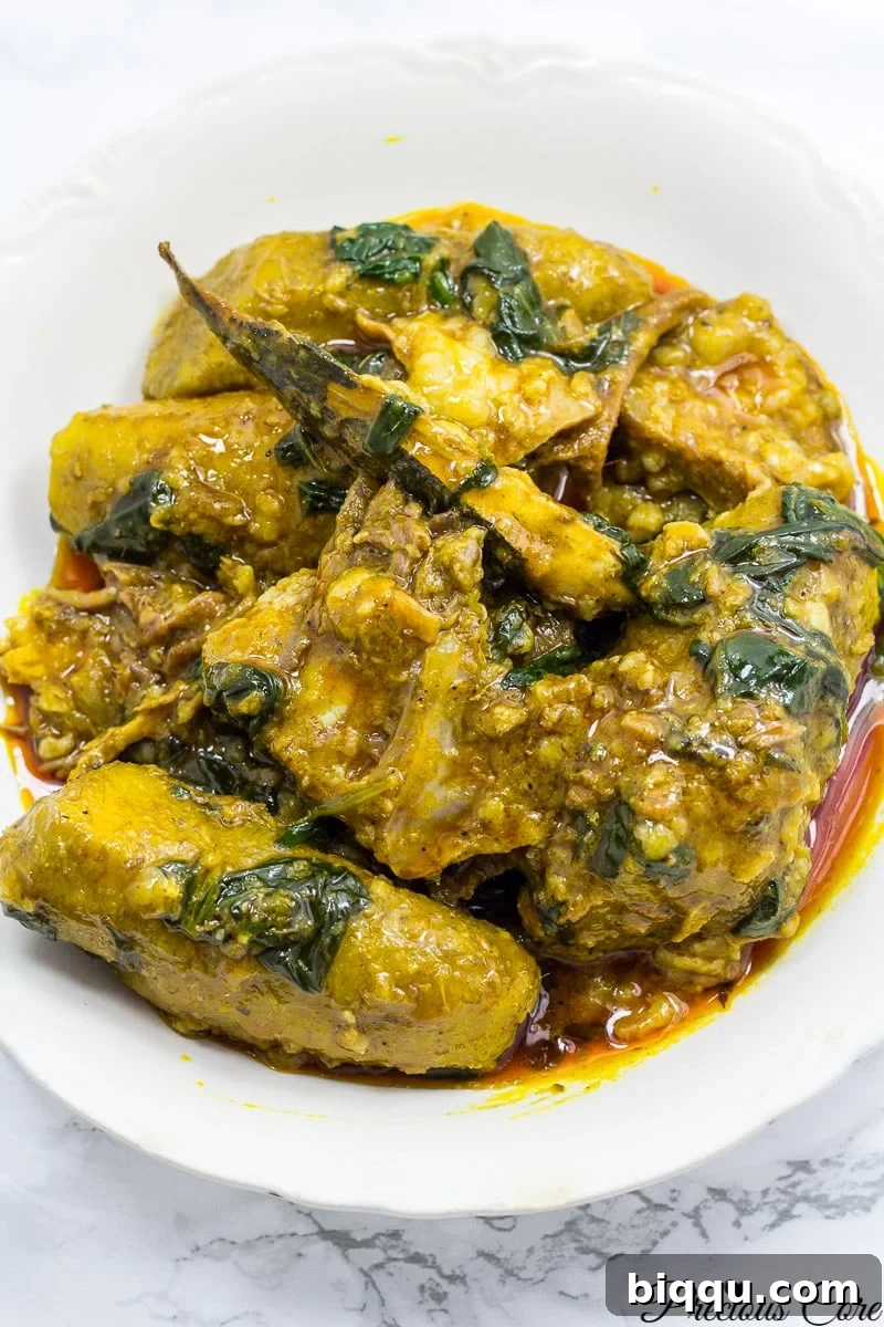 A vibrant, delicious one-pot Cameroonian Plantain Porridge with rich palm oil.