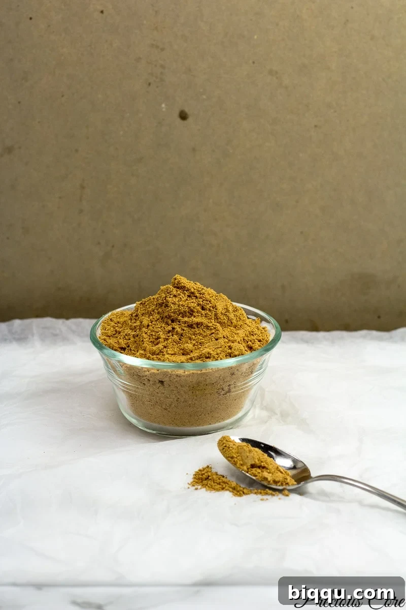 A close-up shot of the finely blended Nigerian suya spice, a rich, reddish-brown powder with speckles of darker spices, ready for use.