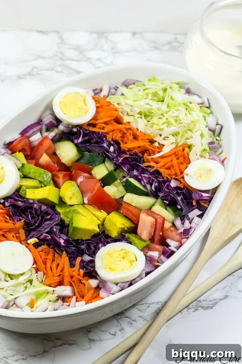 Cameroon salad with hard-boiled eggs, red onion, cucumber, and more.
