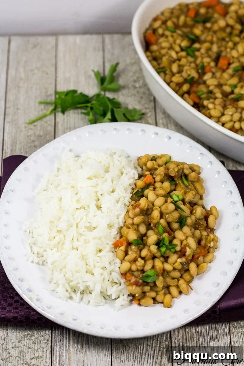 White bean stew served with fluffy white rice on a plate