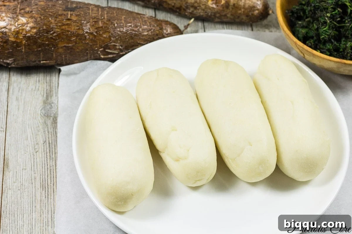 Water fufu or cassava fufu on a white plate, ready to be served.