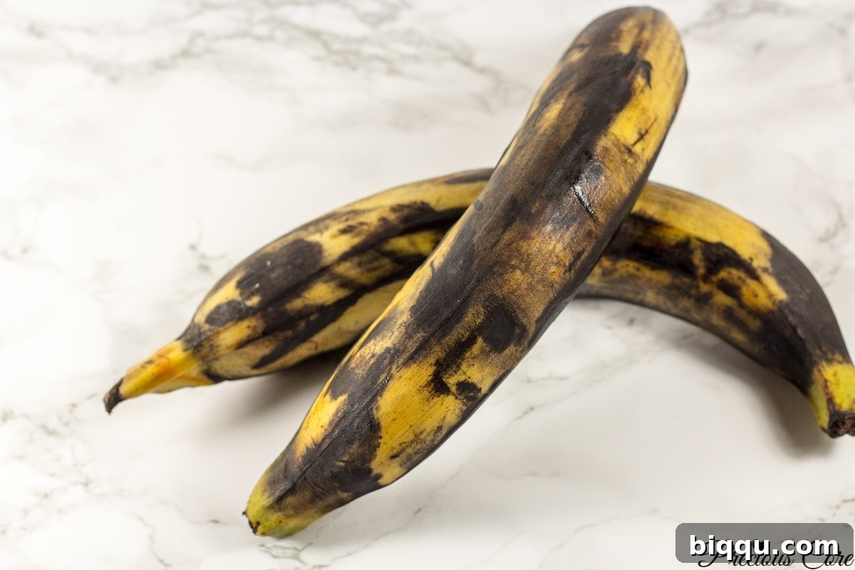 Very brown plantains on a marbled countertop.