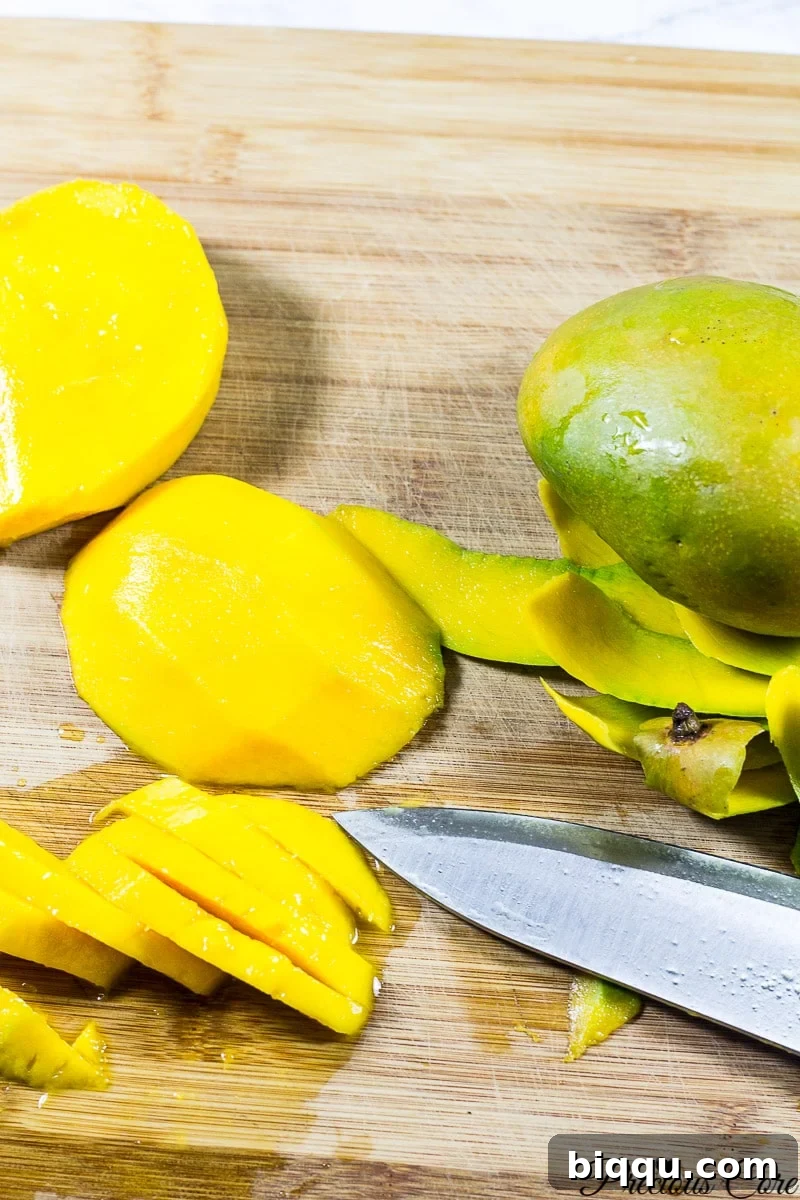 Thickly sliced fresh mangoes arranged for baking