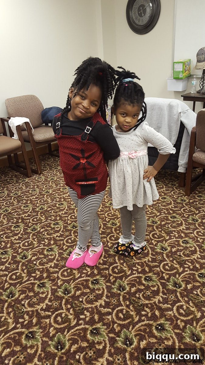 Our Inaugural Homeschool Adventure 4 Two happy girls posing playfully during a homeschooling field trip or family adventure.