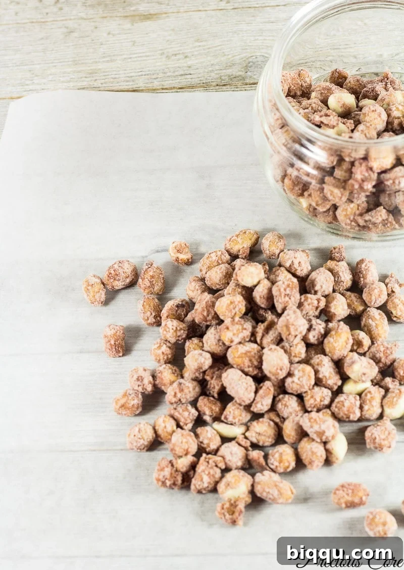 Candied nuts in and around a glass jar.