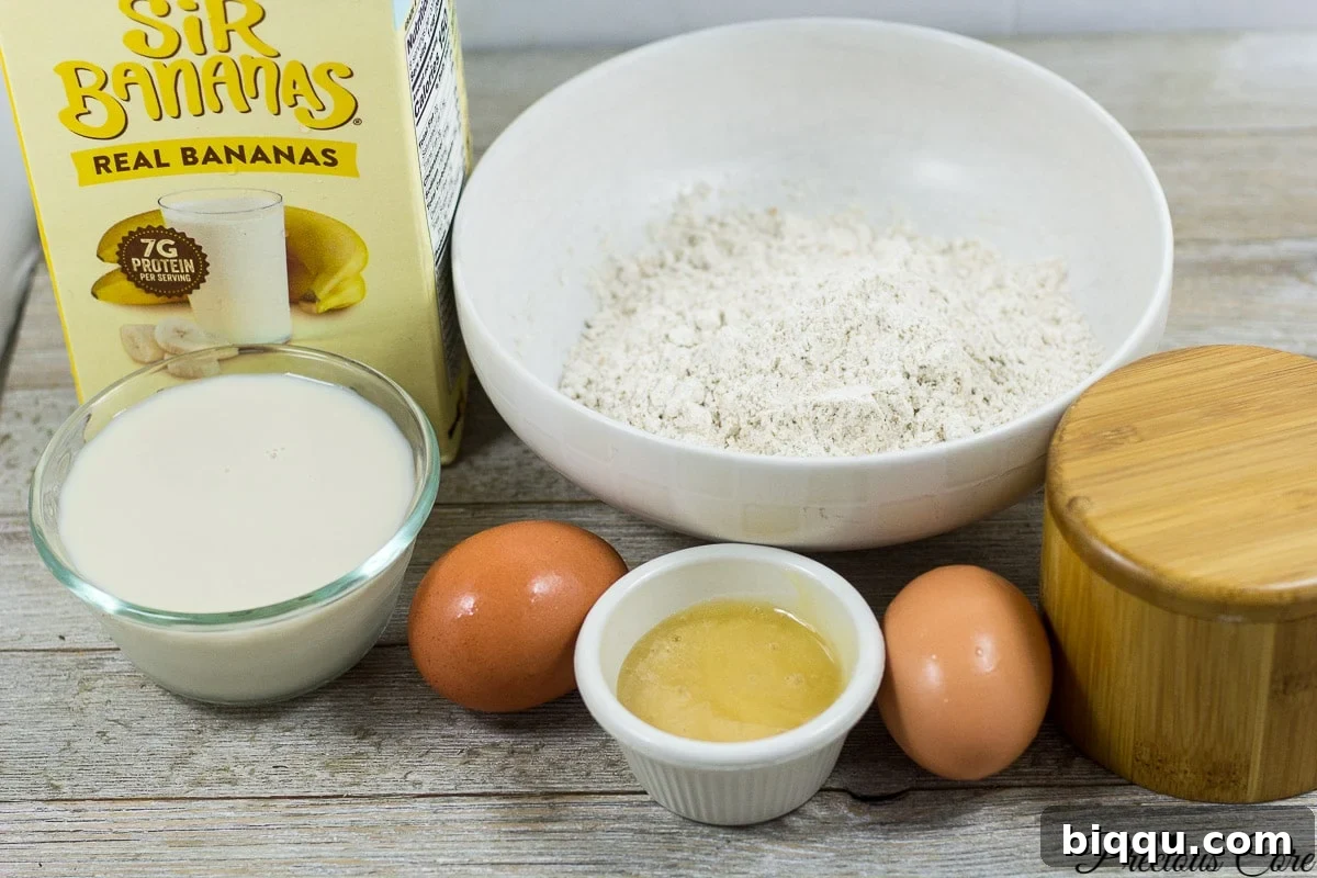 Best banana crepes recipe with batter ingredients laid out on a kitchen counter.
