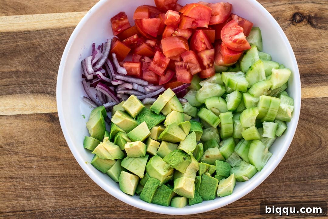 diced avocado, tomato, cucumber, onion in a bowl