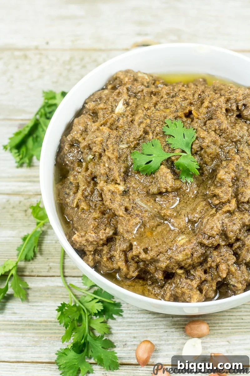 Bowl of groundnut paste, Cameroonian Mboh served with a spoon.