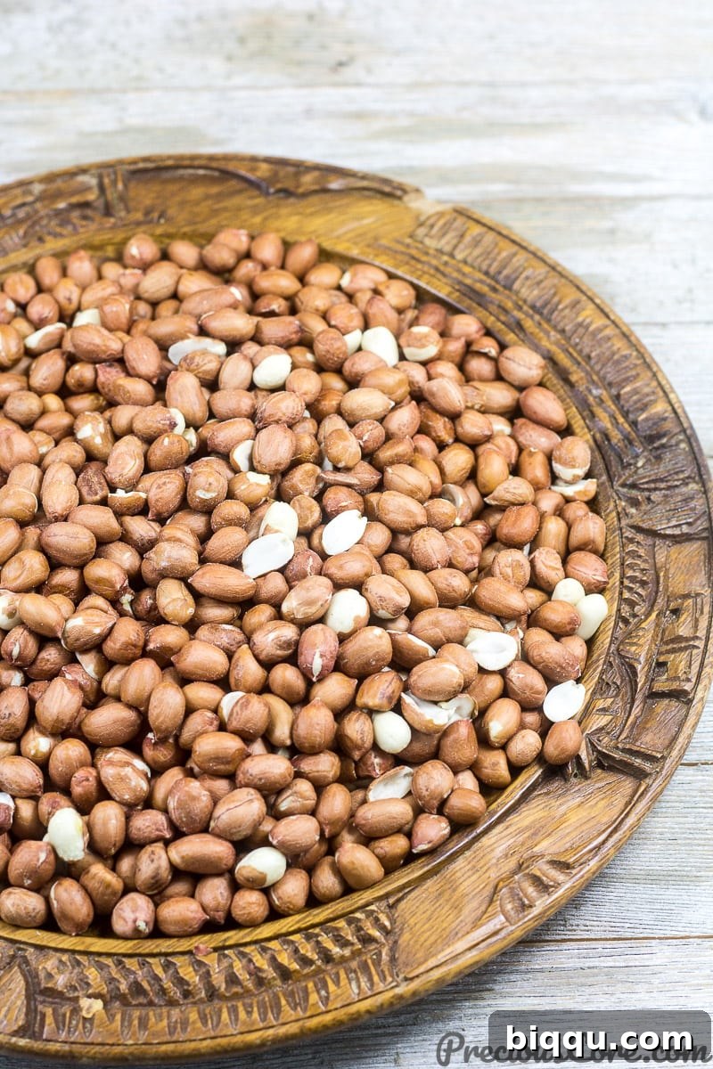 Raw groundnuts in a wooden bowl.