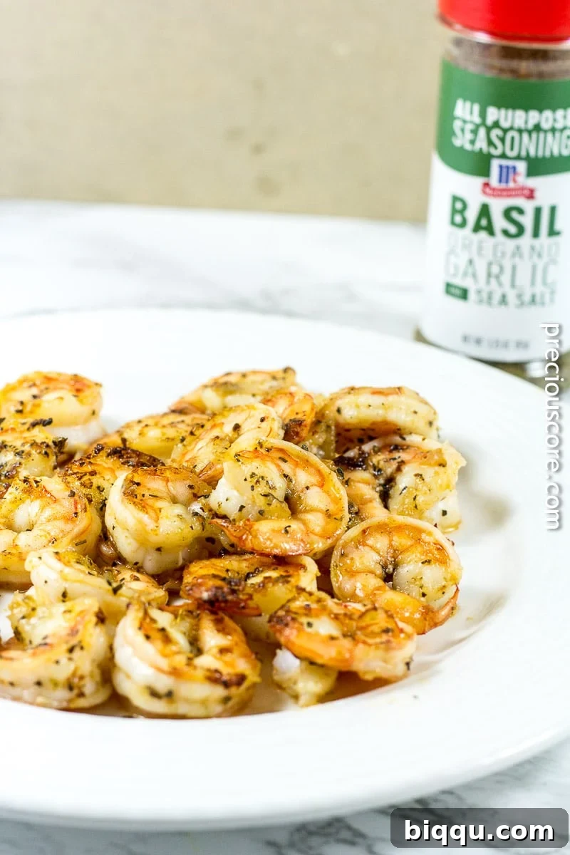 Creole Blackened Shrimp Pasta 6 Shrimp pasta on a plate near a container of all-purpose seasoning.