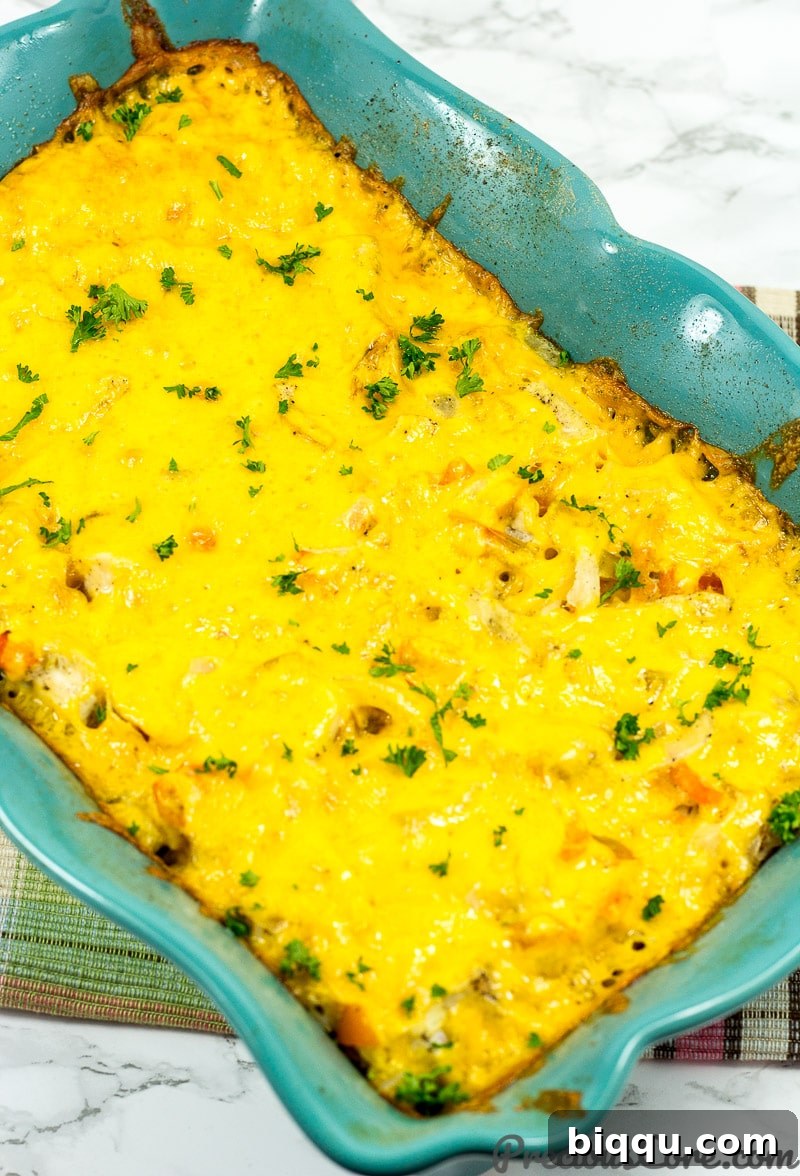 Baked Chicken and Rice Casserole recipe step 3: adding grated cheese for a golden, bubbly topping
