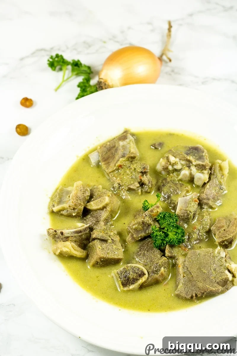 Nigerian goat meat pepper soup recipe, served hot with steam rising.