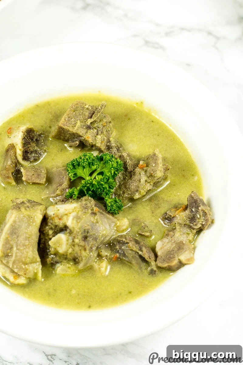 Goat meat pepper soup close-up, highlighting the tender meat pieces.