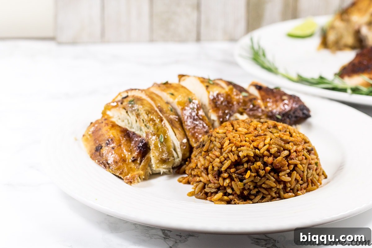 An elegantly presented Thanksgiving Turkey, embodying an African-inspired style, served alongside aromatic Jollof Rice, creating a vibrant holiday meal.