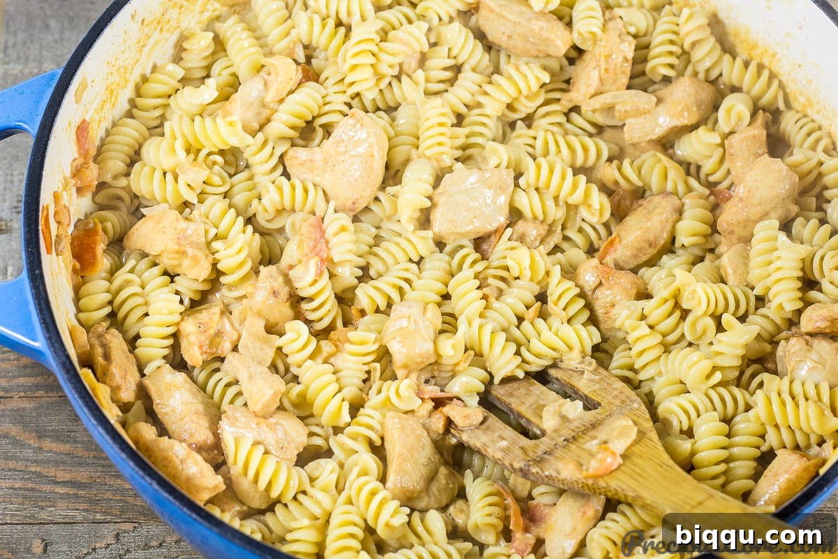 Macaroni and Chicken dinner recipe step 7: stirring macaroni to combine with sauce
