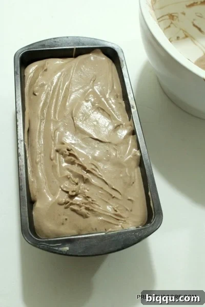 Chocolate ice cream mixture poured into a loaf pan