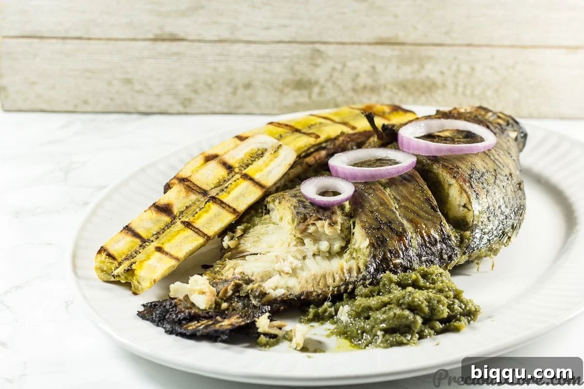 How to eat African grilled tilapia fish with sides