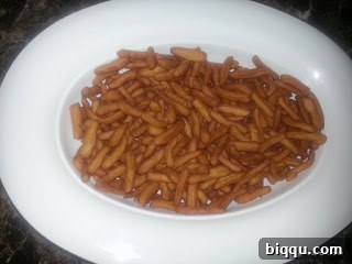 Pile of golden crispy African chin chin in various shapes