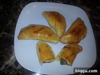 Golden brown African meat pies with a flaky crust