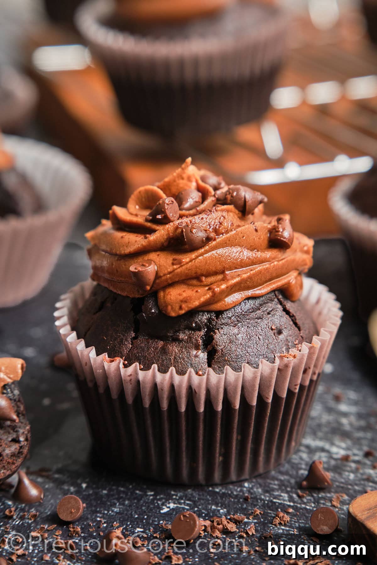 Close-up of a perfectly frosted chocolate cupcake, showcasing its moist texture.