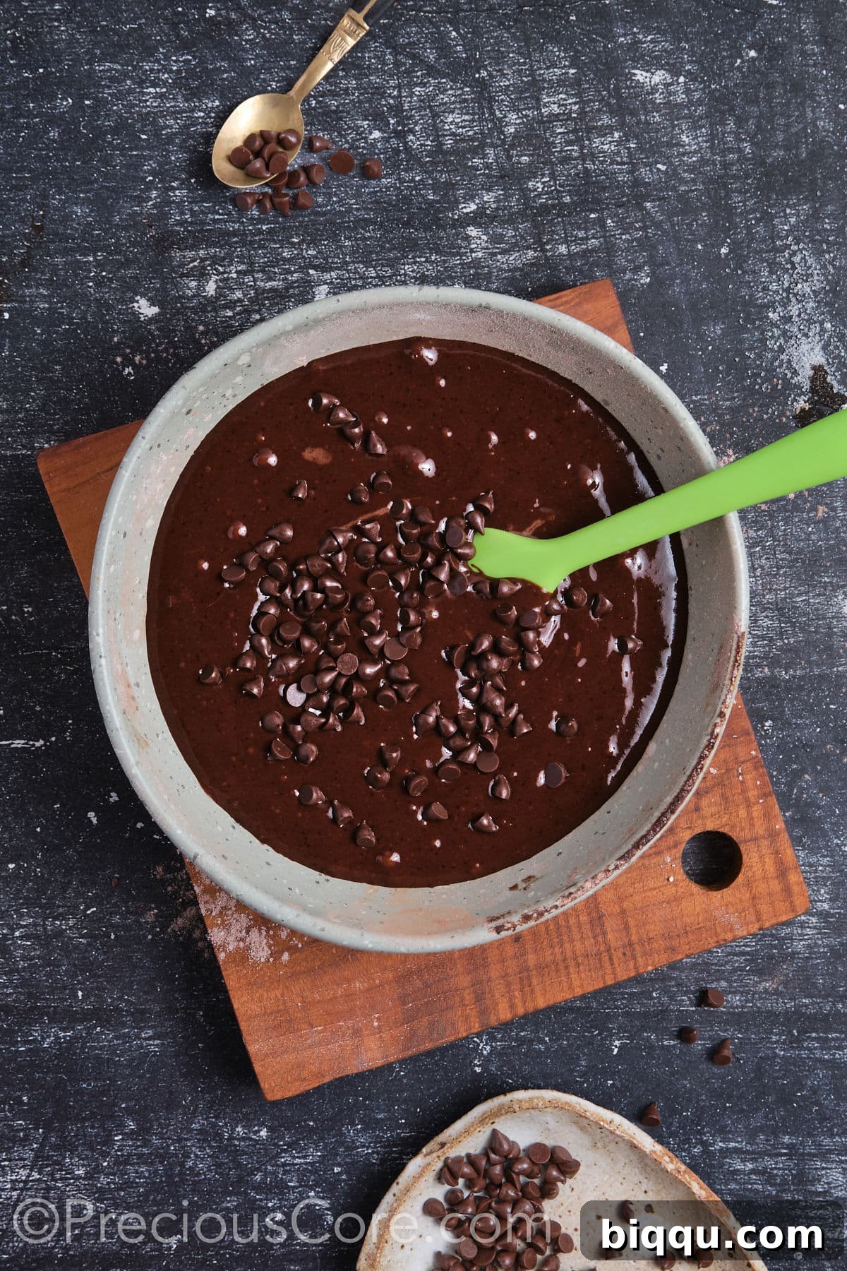 Chocolate chips folded into the cupcake batter in a bowl.