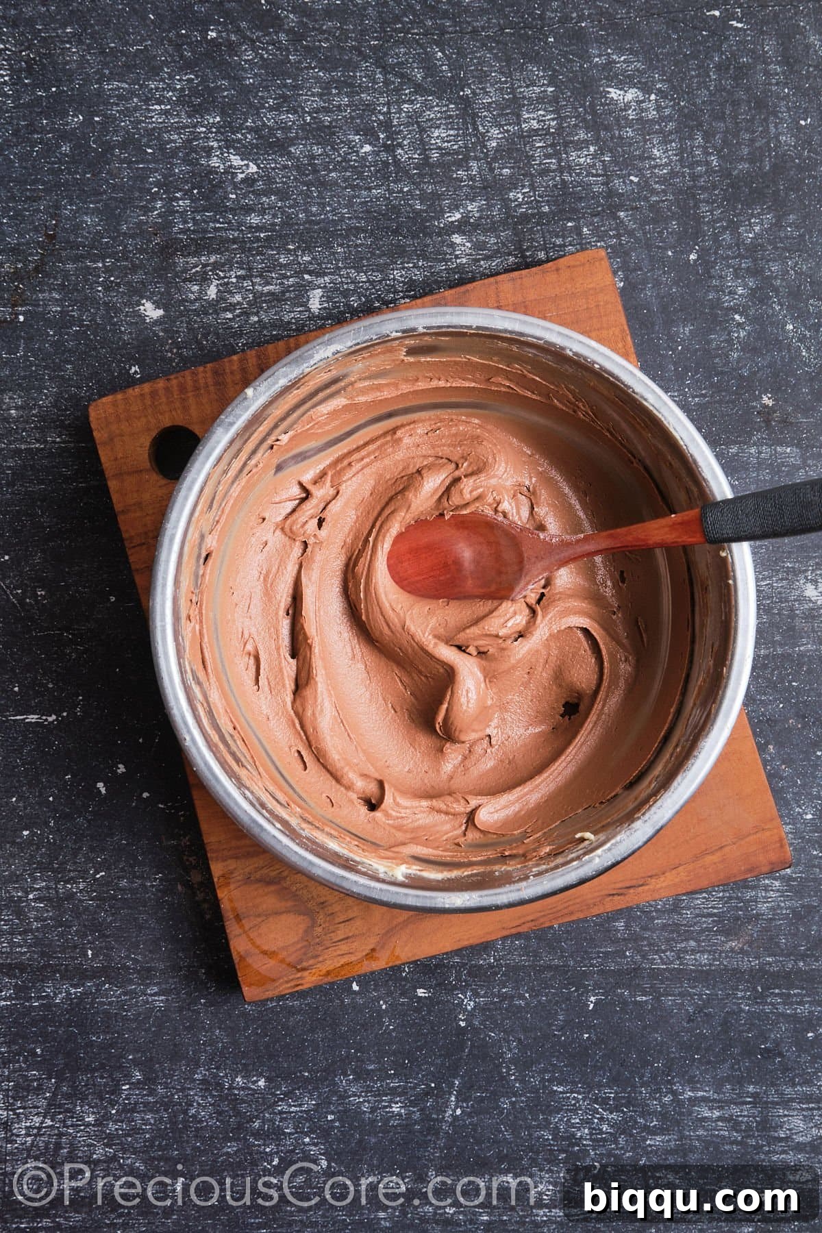 Bowl of rich, whipped chocolate frosting, smooth and ready to use.