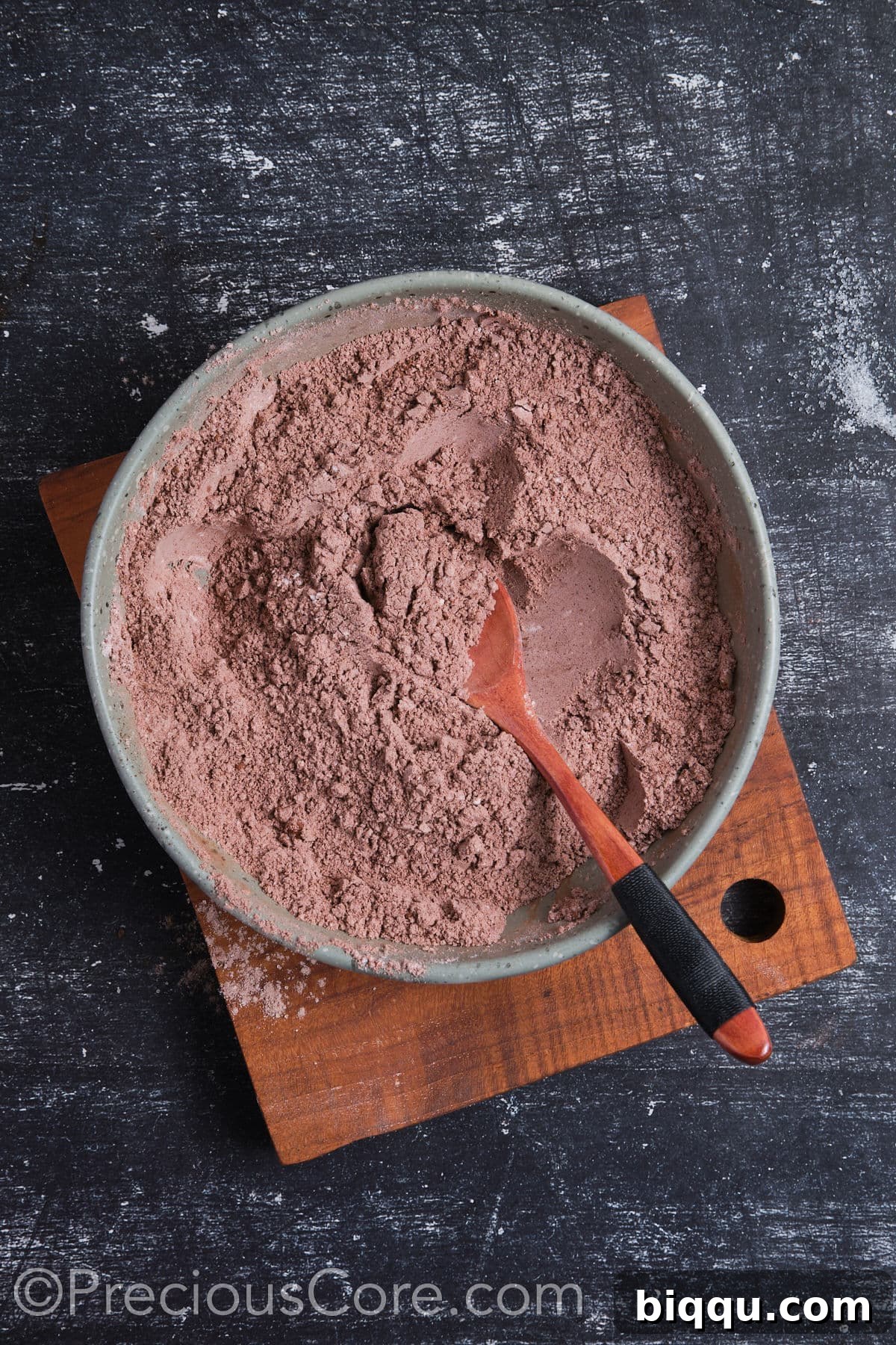 A bowl containing whisked dry ingredients for chocolate cupcakes.