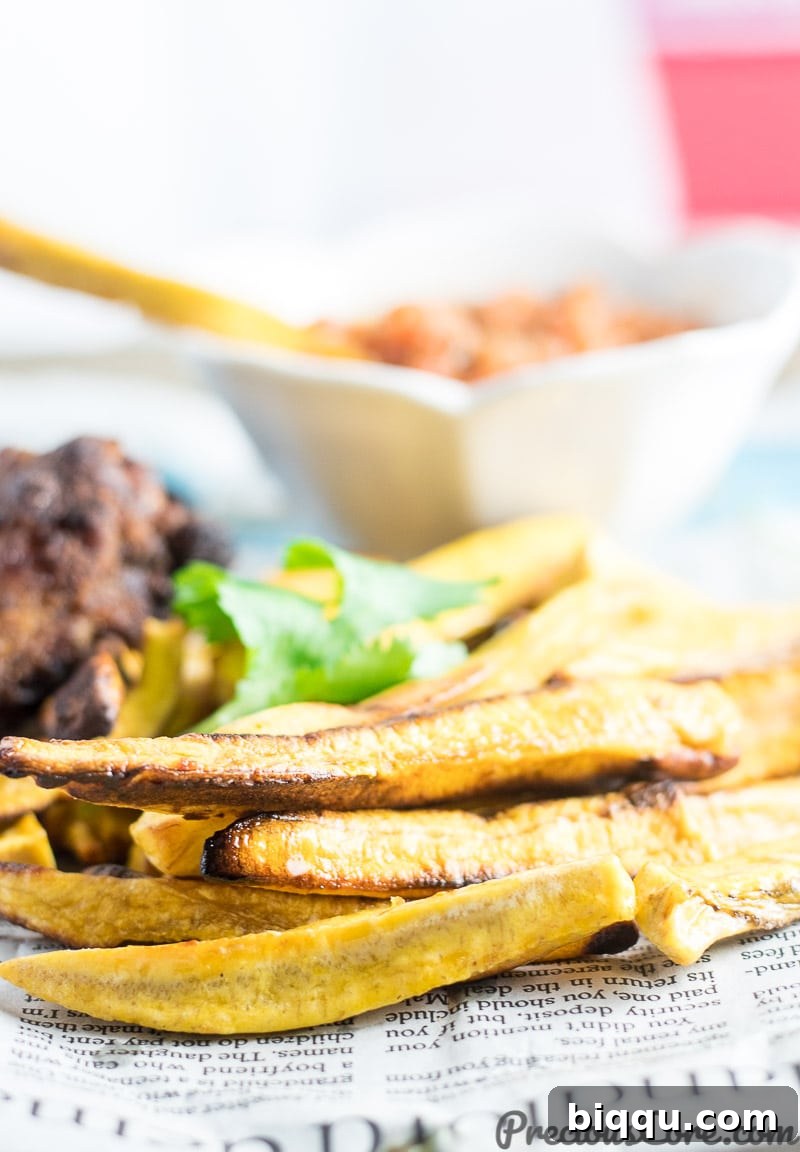 Close-up shot of perfectly golden, crispy fries made from semi-ripe plantains, showcasing their appealing texture.