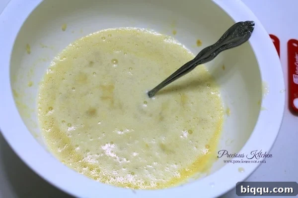 Mixing mashed bananas and eggs with milk