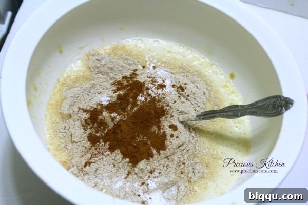Adding dry ingredients like flour and spices to the wet banana mixture