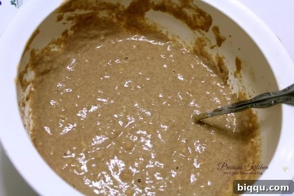 Mixing whole wheat banana pancake batter until just combined