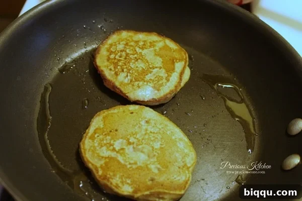 Flipping a whole wheat banana pancake on a frying pan