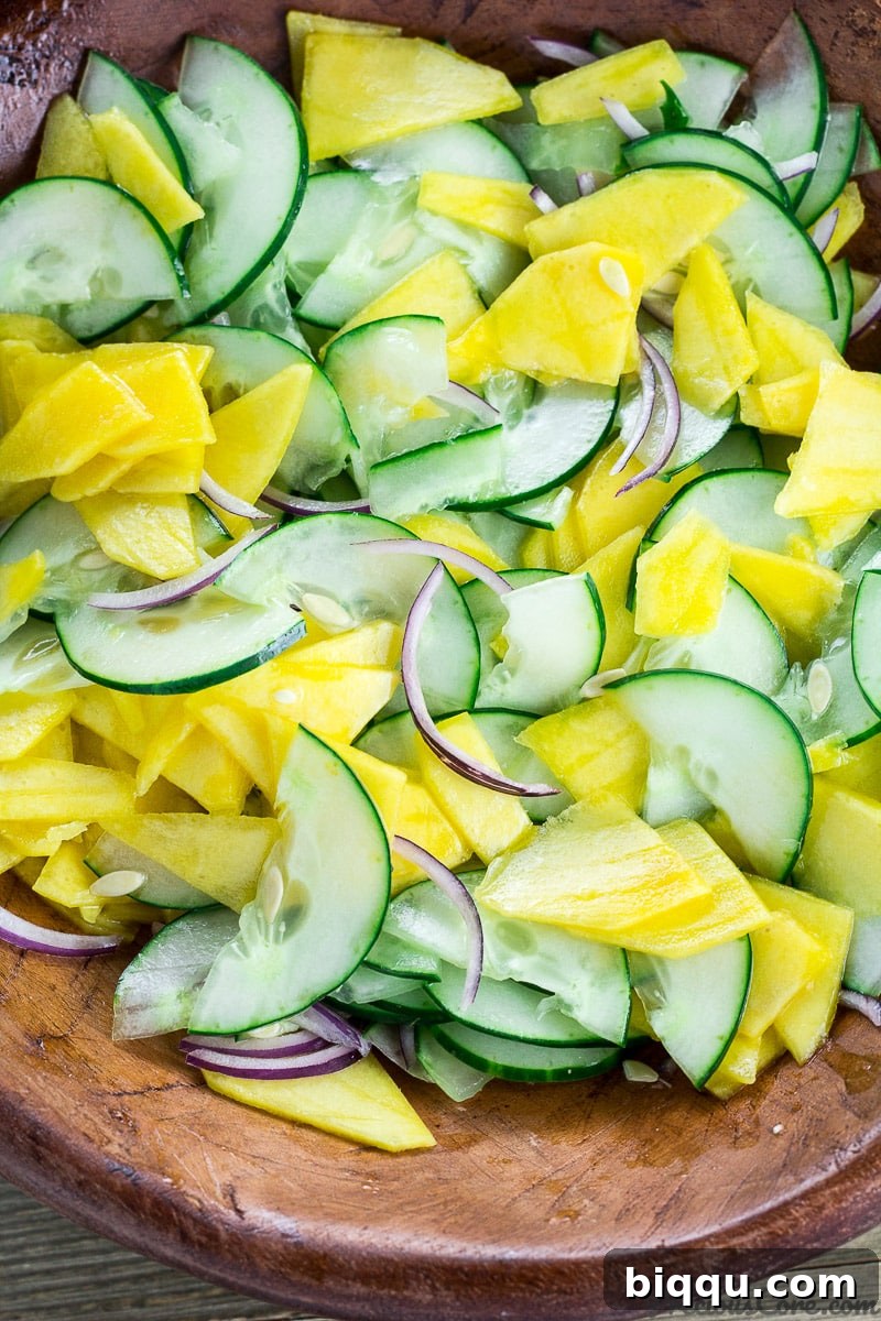 Refreshing Cucumber Mango Salad 2 Cucumber Mango Salad tossed in a bowl, showcasing its vibrant colors