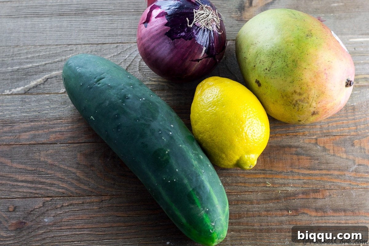 Refreshing Cucumber Mango Salad 4 Fresh ingredients for cucumber mango salad including cucumber, mango, red onion, and lemon