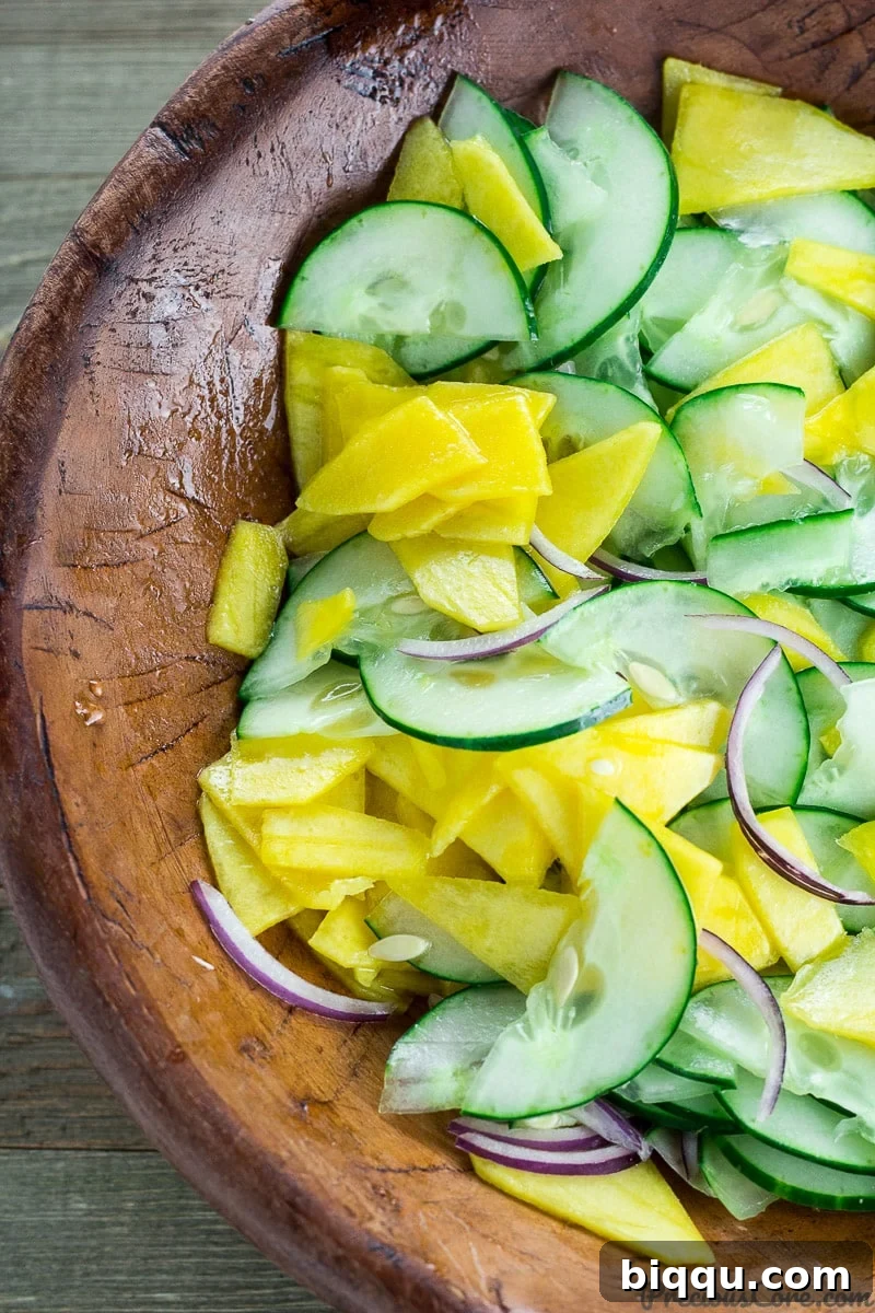 Refreshing Cucumber Mango Salad 6 Mango cucumber salad in a rustic wooden bowl