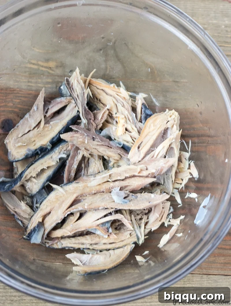 Cooked fish fillet in a bowl, ready for mashing for African Fish Balls
