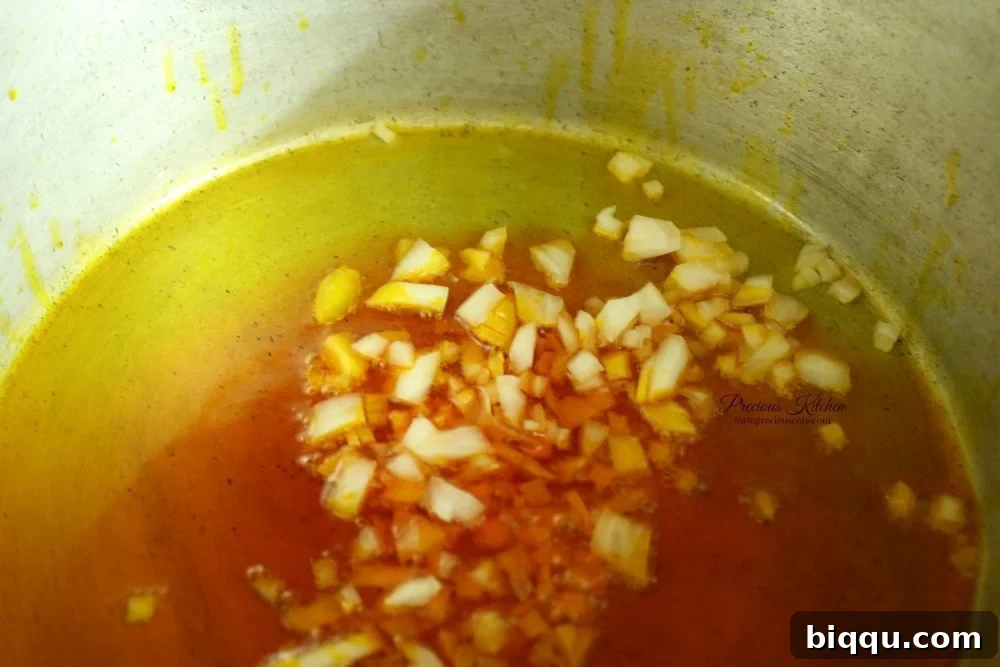Chopped onions sizzling in warm palm oil for Tukuni