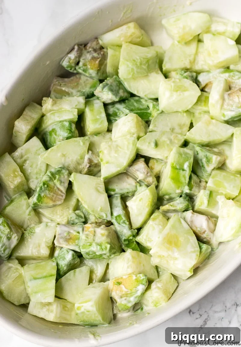 Cucumber Avocado Salad tossed with dressing