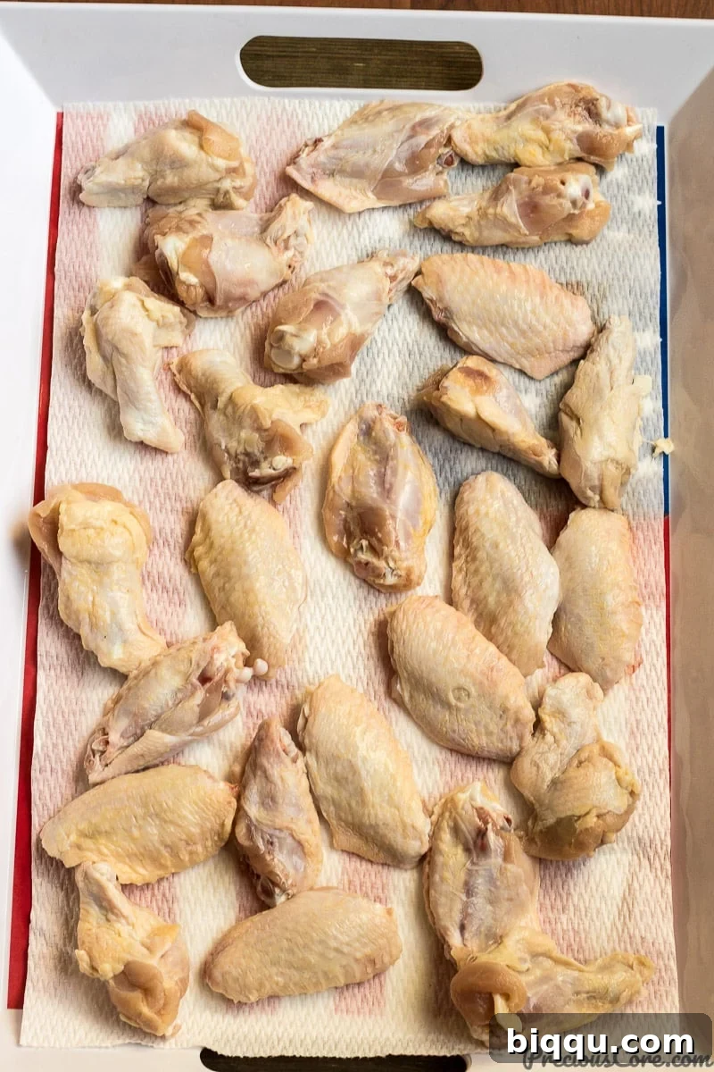 Freshly washed party wings, meticulously cleaned and ready for seasoning, showcasing the quality of the chicken.