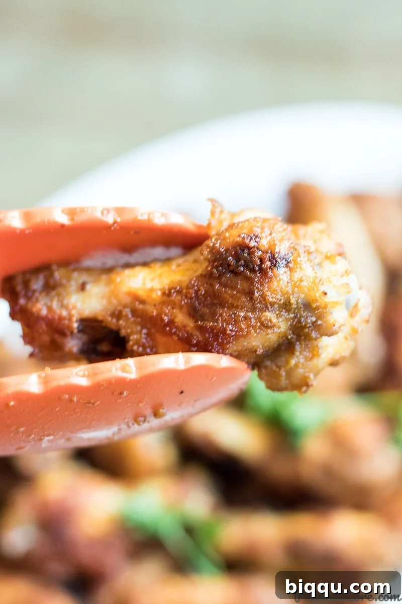 A close-up of epic oven-grilled chicken wings, showing their irresistible crispy skin and succulent texture, ready to be enjoyed.