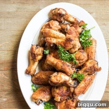 Super crispy epic oven grilled chicken wings, golden-brown and glistening with flavorful spices.