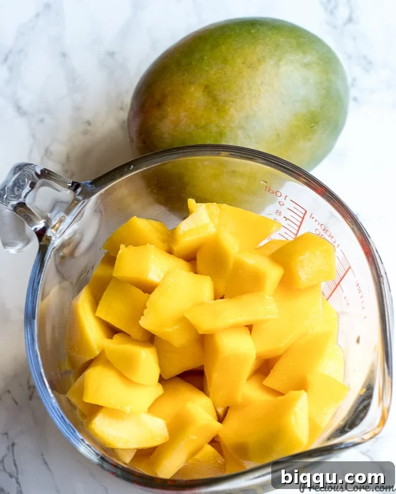 A cup of peeled and diced mangoes for mango juice
