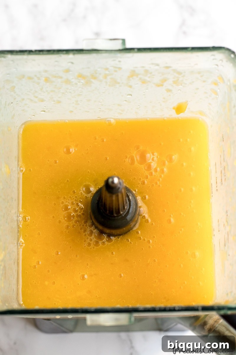 Freshly blended mango juice in a blender