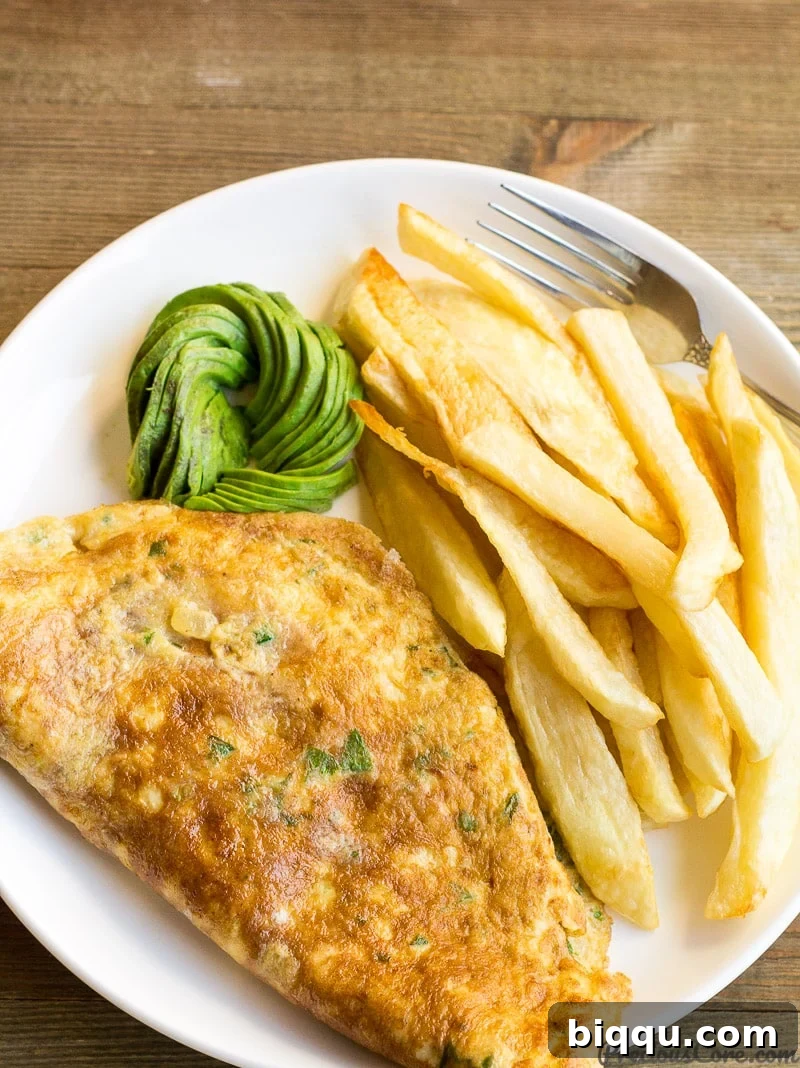 Delicious African Fried Potatoes and Omelet with Fresh Avocado Slices