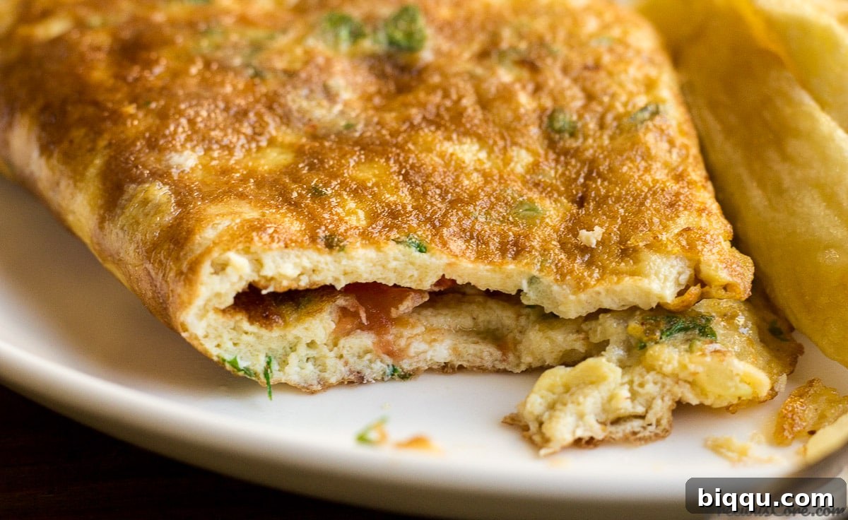 Close-up of a perfectly cooked African omelette with a bite taken out